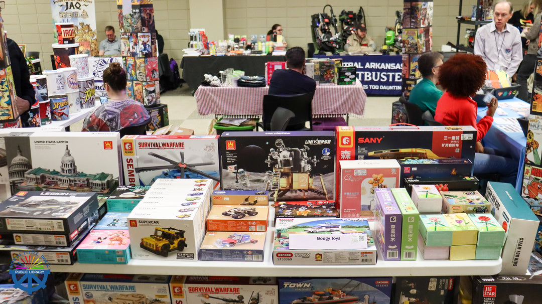 Table with model kits and hobby supplies from Googy Toys at the Laman Con event.