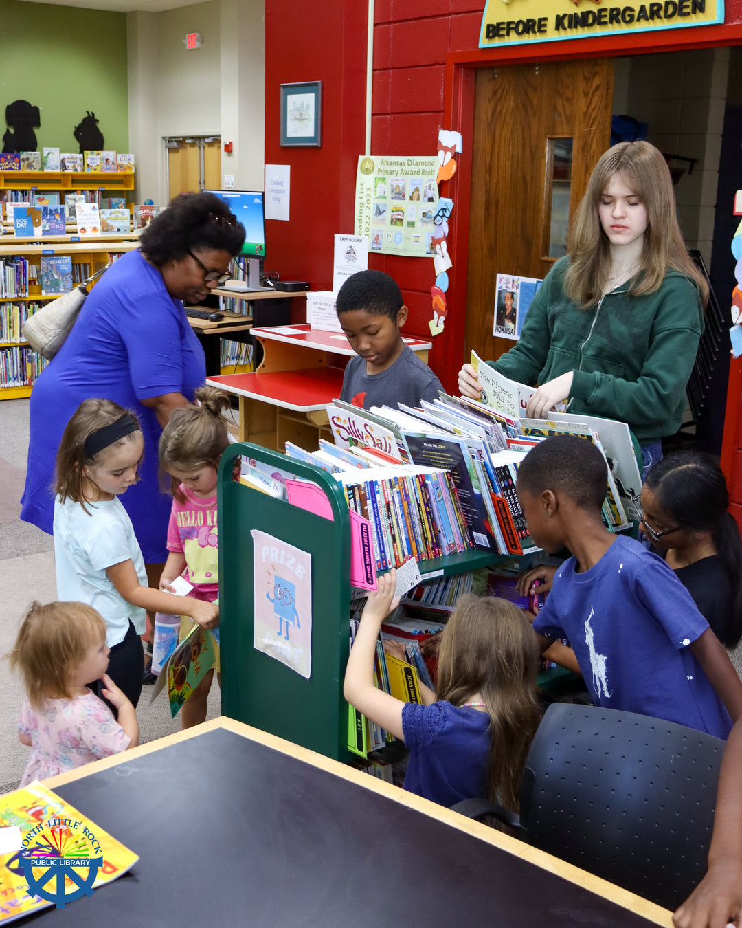A group of children browse books at the William F. Laman Library.