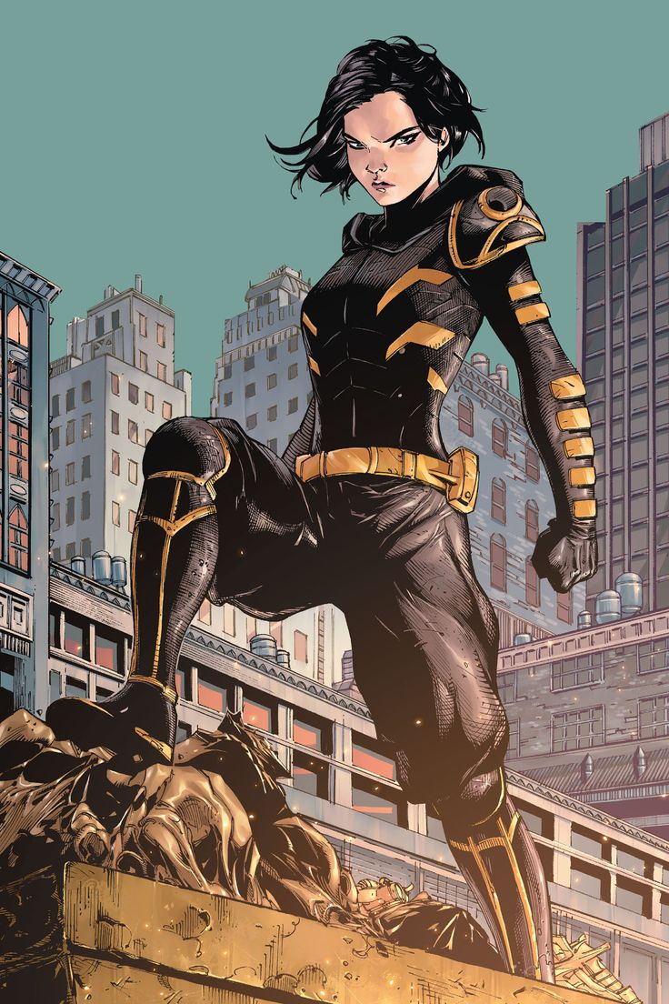Comic book character Orphan, a woman with pale skin and dark hair wearing a black and yellow outfit, poses dramatically on top of a building.
