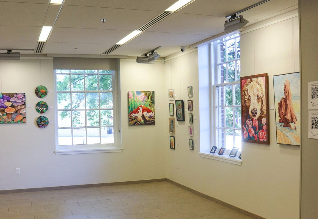 Art gallery with colorful artwork hung on the walls.