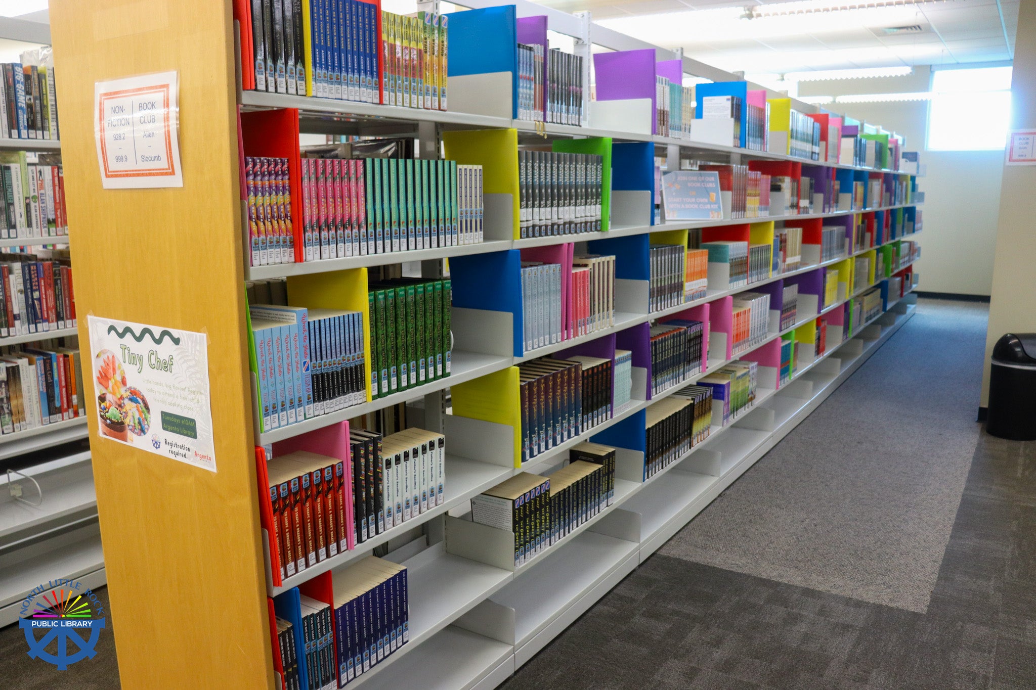 Shelves of colorful collections of books ready to be checked out.