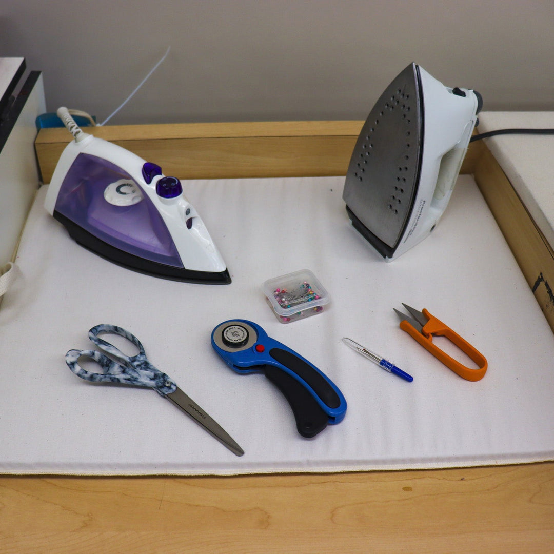Two irons and assorted small sewing tools for use in the library's Makerspace.