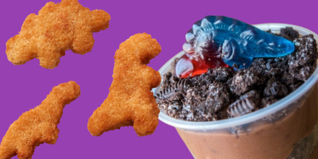 A purple background with three chicken nuggets shaped like dinosaurs and a cup of chocolate pudding topped with crushed cookies and a gummy dinosaur.