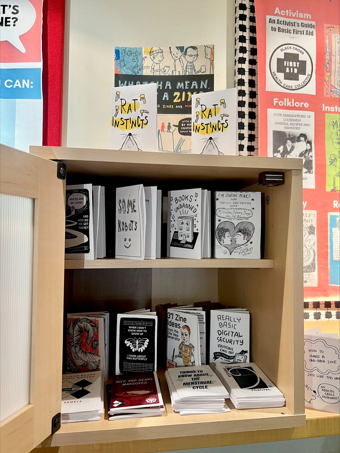 An open cabinet with zines on a variety of topics inside.