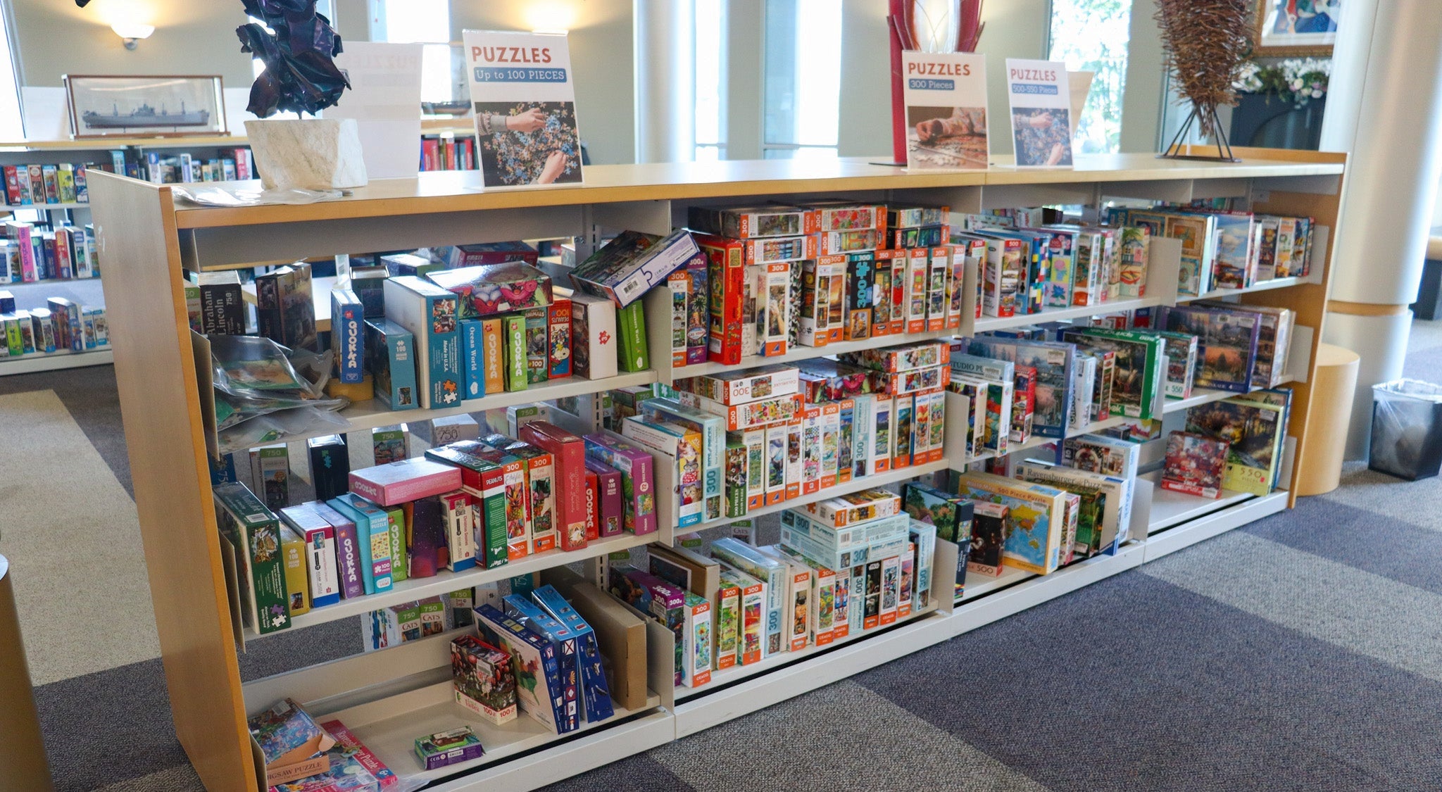 Shelf with colorful puzzles for all ages.