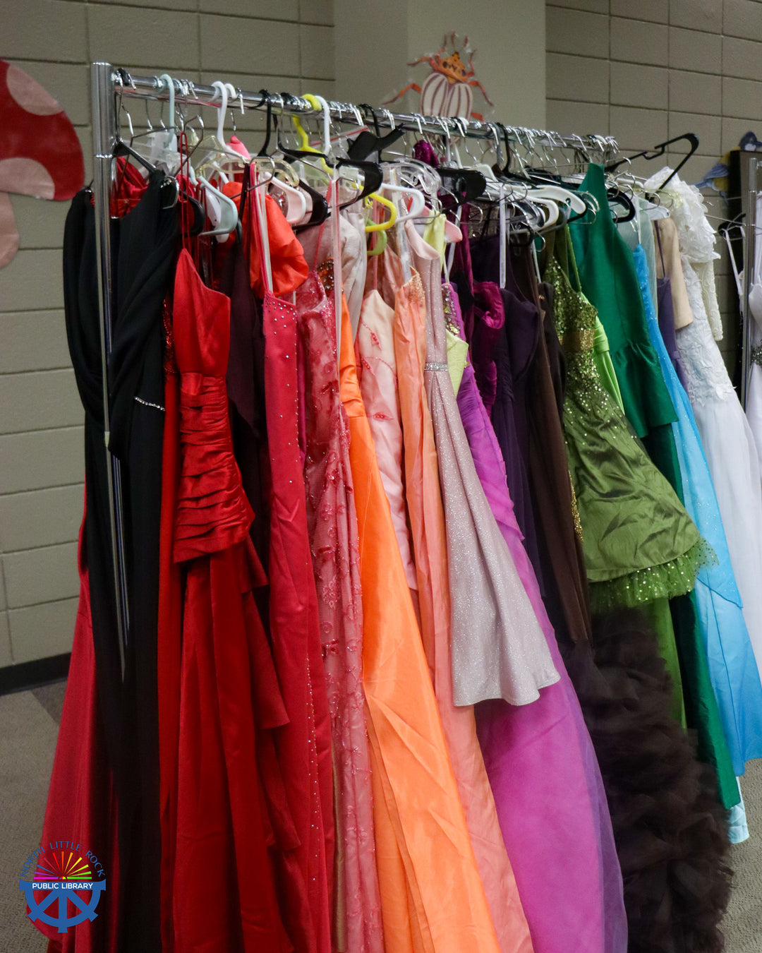 A rack of colorful formal dresses.