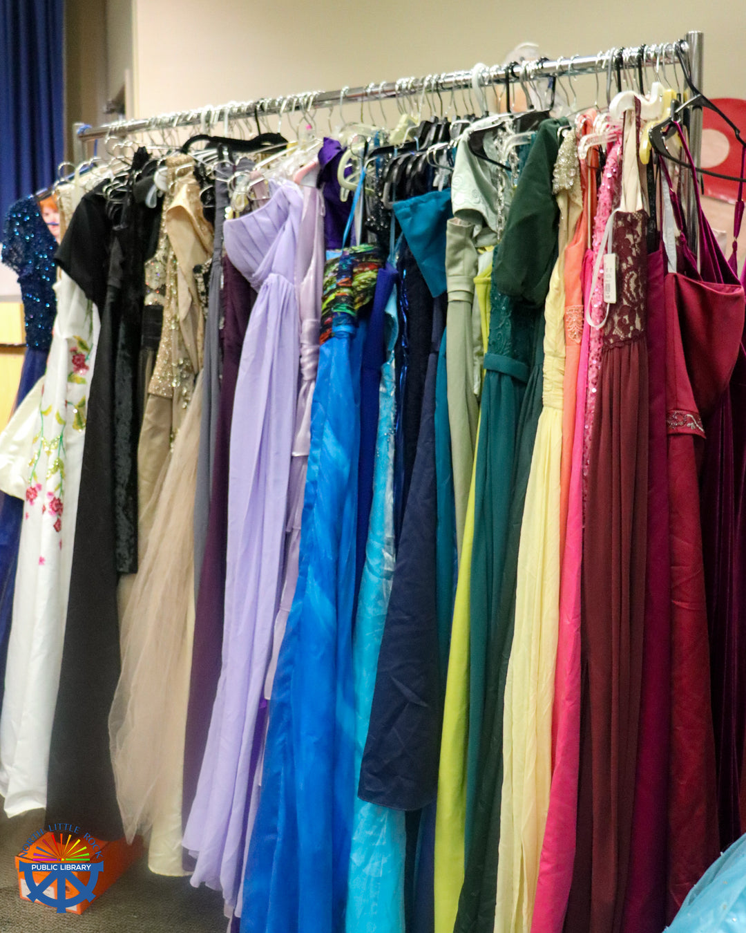 Another rack of colorful formal dresses.