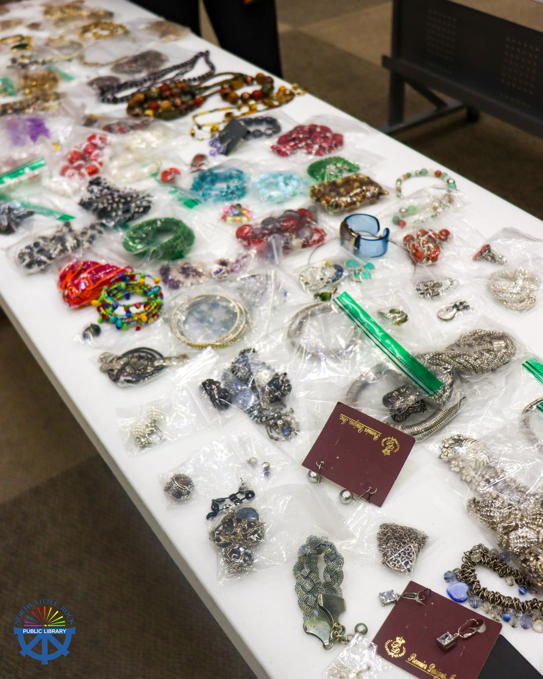 Colorful costume jewelry on a white banquet table.