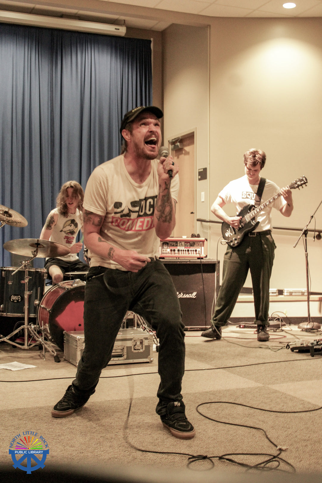 A group of three musicians perform a song,