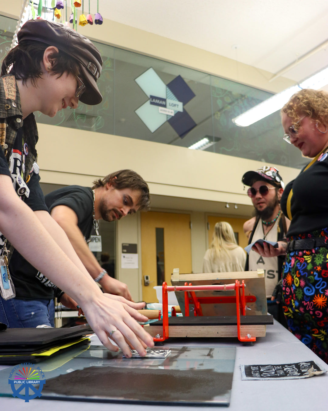 Aaron and Carter from Mobile Makerspace demonstrate the block printing process to punk show attendees.