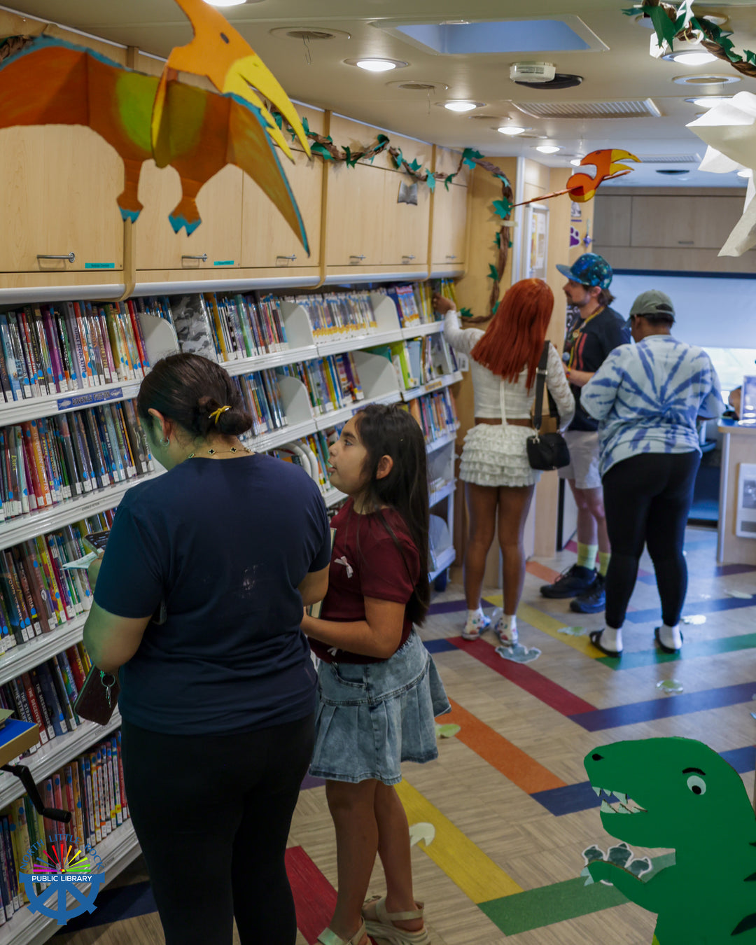 Library patrons browse for books and movies aboard Rover, North Little Rock's mobile library.
