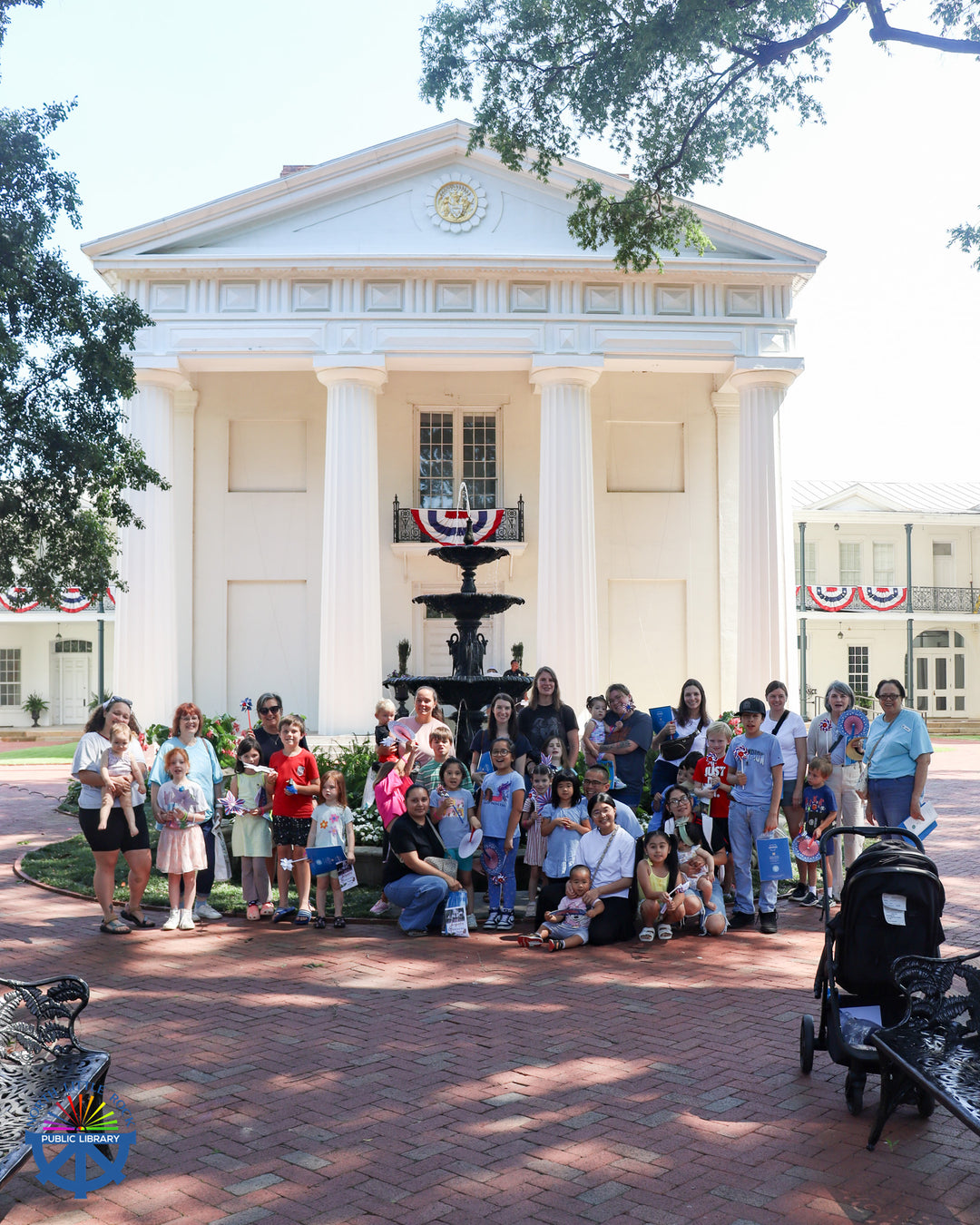 Adventure Walk attendees gather for a group photo outside the Old Statehouse Museum.