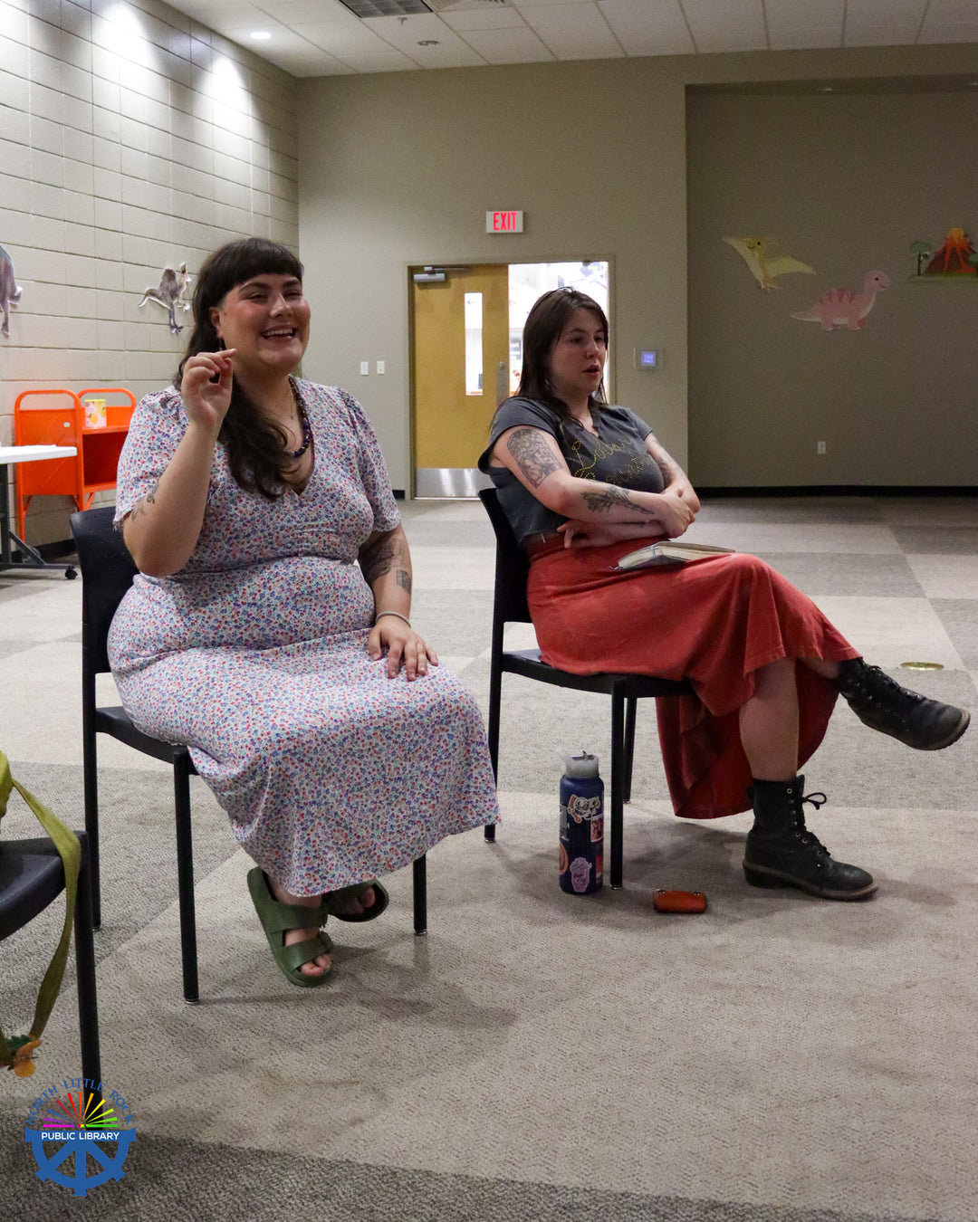 Two seated people sing and gesture during an Estonian Folk Singing workshop.