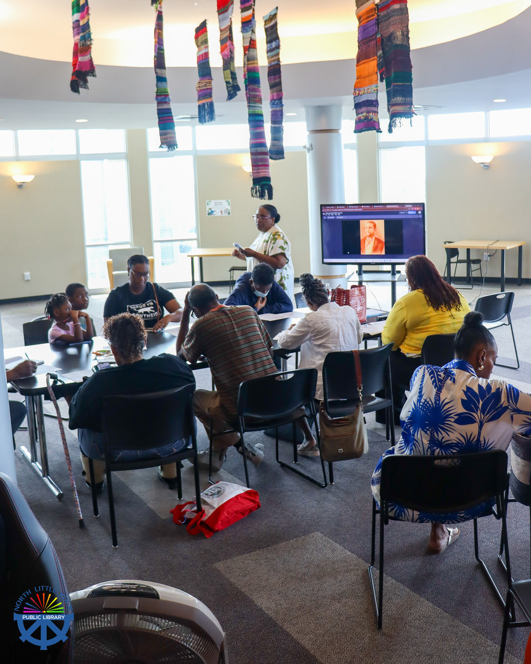 A presenter leads a cemetery preservation workshop for seated attendees.