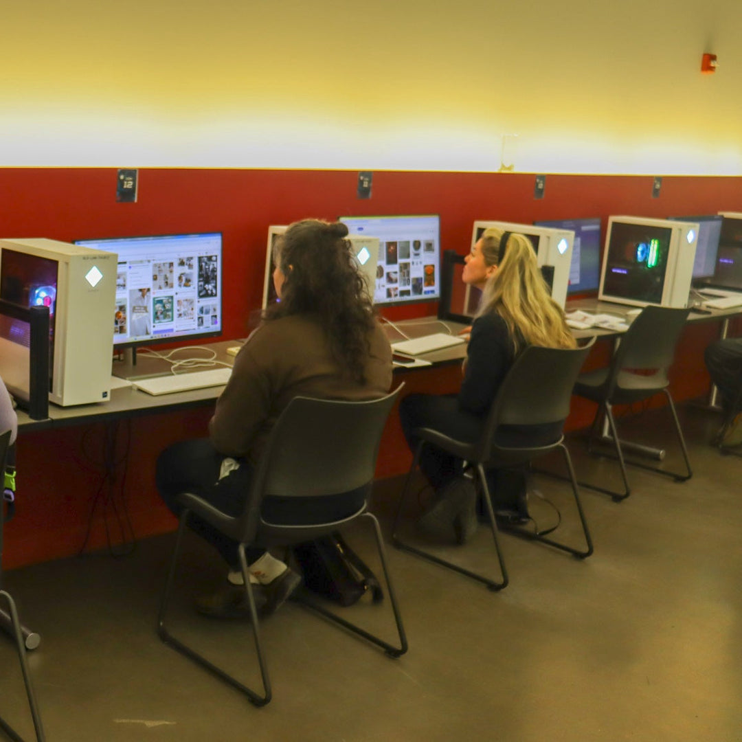 People seated and working at computers.