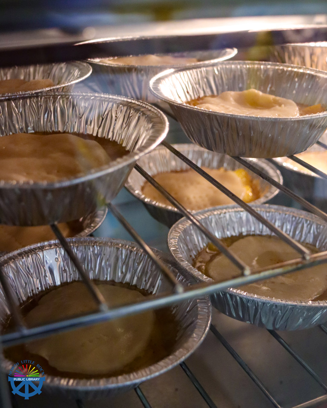Closeup of small apple pies in an oven.