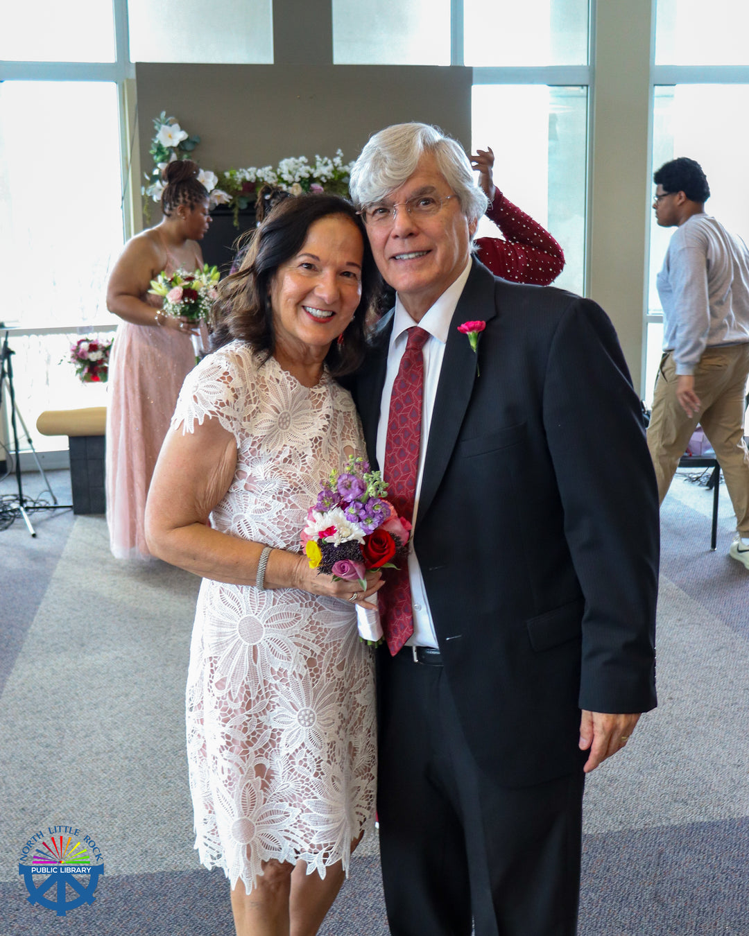 A couple in wedding attire after their vow renewal.
