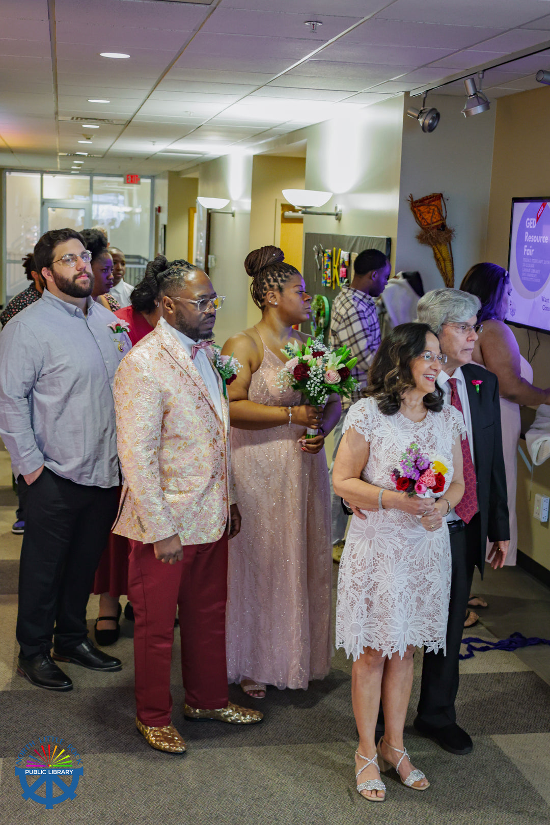 A group of wedding participants wait for the processional to begin.
