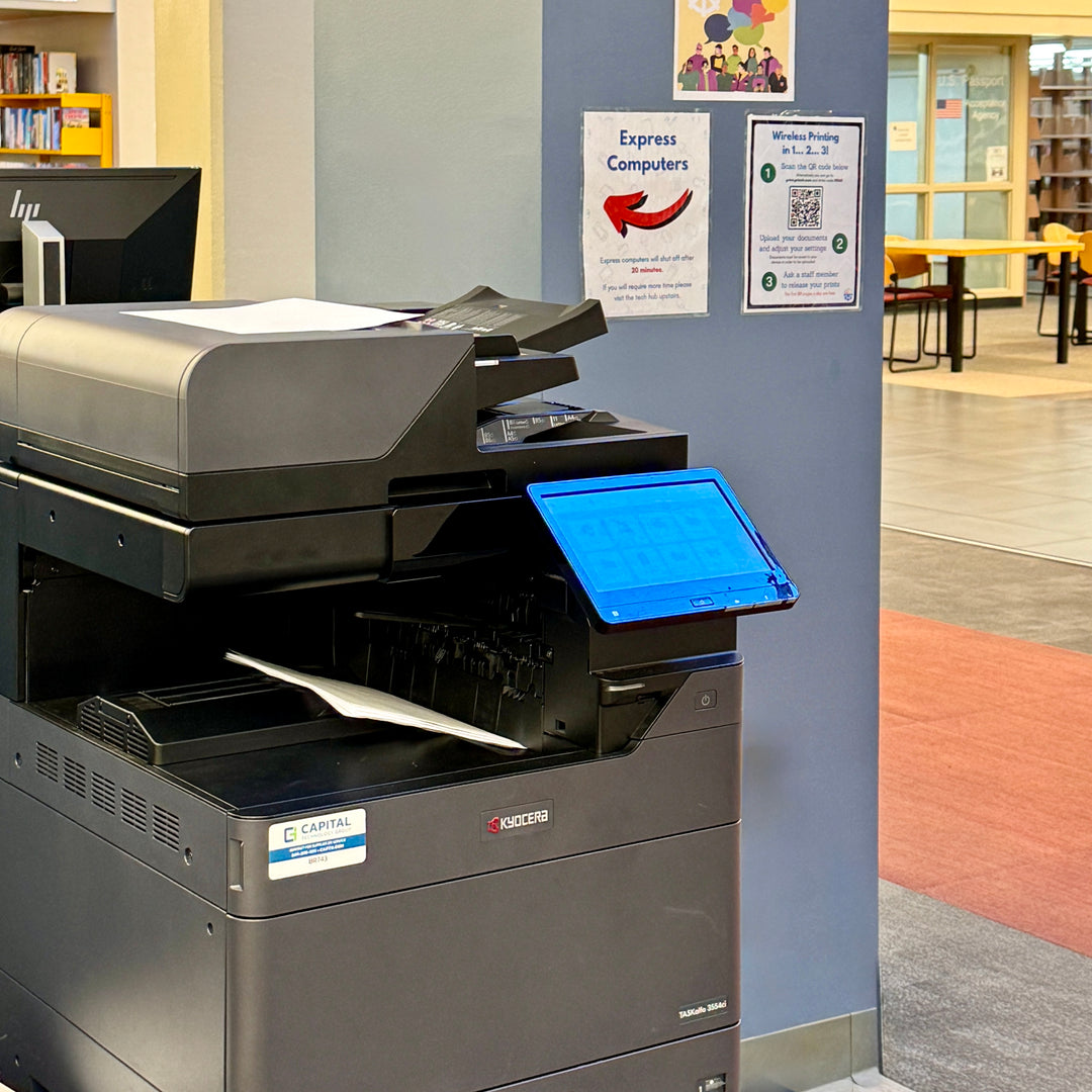 A kyocera printer is making copies of a patron's files sent to the wireless printer system.